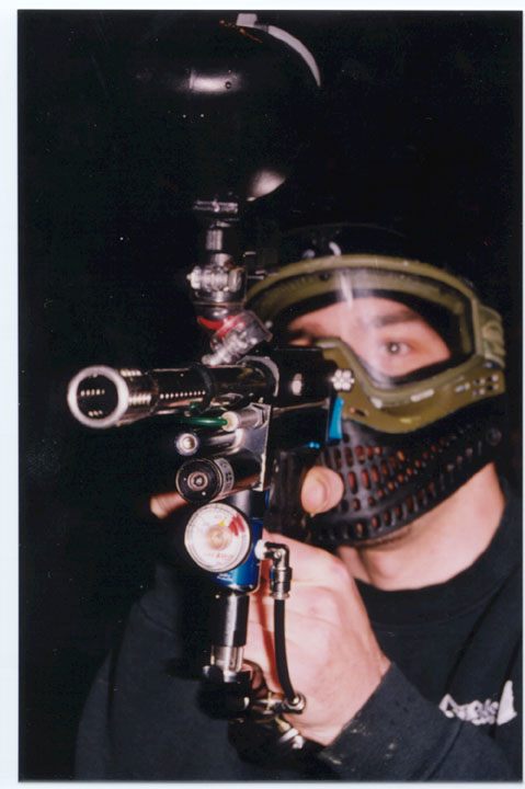 Paintball player photographed in action on the field.