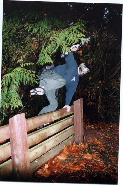 Paintball player photographed mid-point with marker in hand.